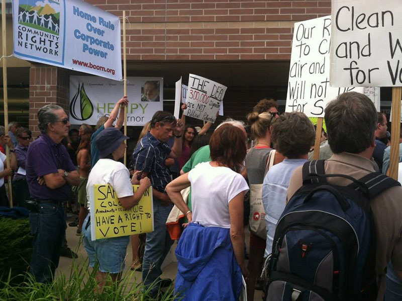 Protesting Jared Polis's decision at a town hall in 2014