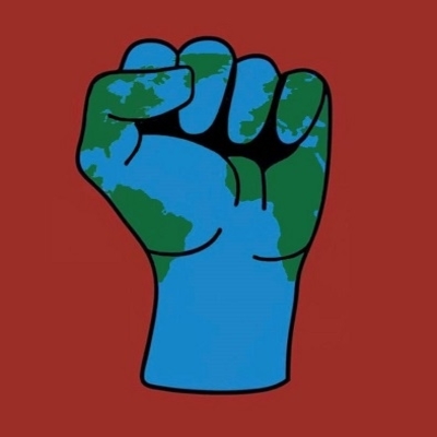 A fist pointed upwards is blue with green marks that are shaped like countries. 