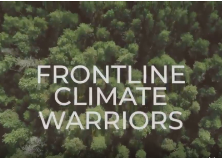 An aerial view of a forest with the words "Frontline Climate Warriors"