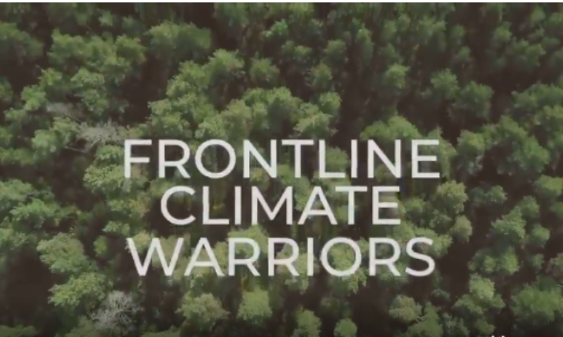 An aerial view of a forest with the words "Frontline Climate Warriors"